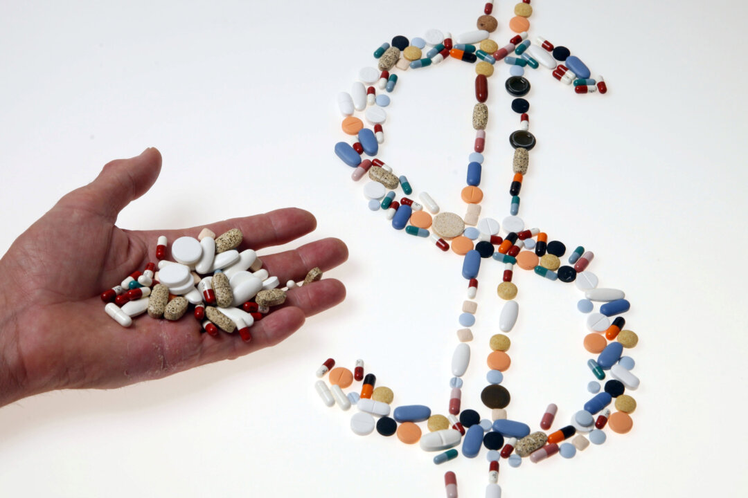 Pharmaceutical tablets and capsules are arranged in the shape of a U.S. dollar sign on a table in this picture illustration taken in Ljubljana, Slovenia, on Aug. 20, 2014. (Srdjan Zivulovic/Reuters)