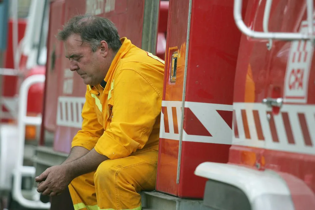 A Victorian firefighter takes a rest at the Halls Gap fire base in the Grampians mountain range in Victoria, Australia on Jan. 27, 2006. (Lucas Dawson/Getty Images)