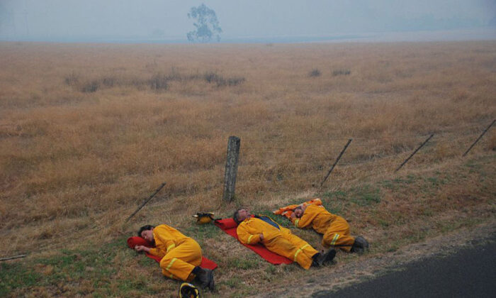 TAGGETY, AUSTRALIA - FEBRUARY 8: In this handout image supplied by Stephen Henderson of the County Fire Authority,  Firefighters of the CFA Strike Teams (Milawa CFA Tanker) rest after fighting to save the township of Taggety from bush fires on February 8, 2009 in Taggety, near Marysville, in Victoria, Australia.  Victoria Police have revised the bushfire disaster death toll to 181, the worst in Australia's history. (Photo by Stephen Henderson/CFA via Getty Images)