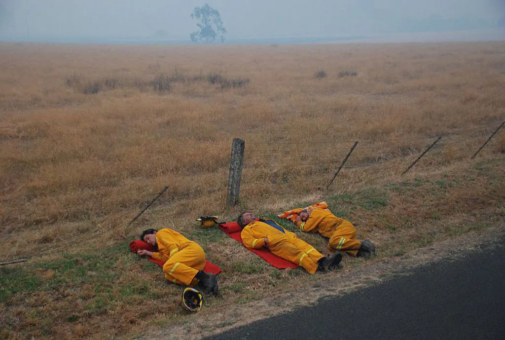 In this handout image supplied by Stephen Henderson of the County Fire Authority, Firefighters of the CFA Strike Teams (Milawa CFA Tanker) rest after fighting to save the township of Taggety from bush fires on Feb. 8, 2009 in Taggety, near Marysville, in Victoria, Australia. (Photo by Stephen Henderson/CFA via Getty Images)