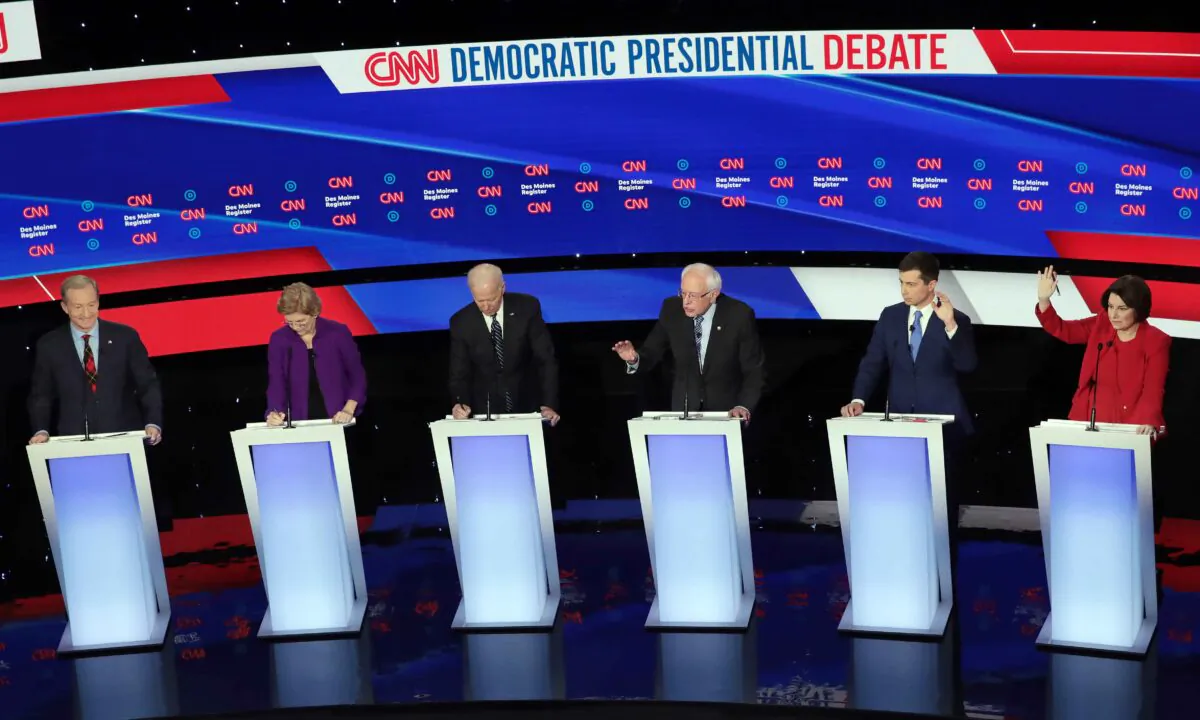 (L-R) Tom Steyer, Sen. Elizabeth Warren (D-Mass.), former Vice President Joe Biden, former South Bend, Indiana Mayor Pete Buttigieg and Sen. Amy Klobuchar (D-Minn.) listen as Sen. Bernie Sanders (I-Vt.) (3rd R) speaks during the Democratic presidential primary debate at Drake University in Des Moines, Iowa, on Jan. 14, 2020. Scott Olson/Getty Images