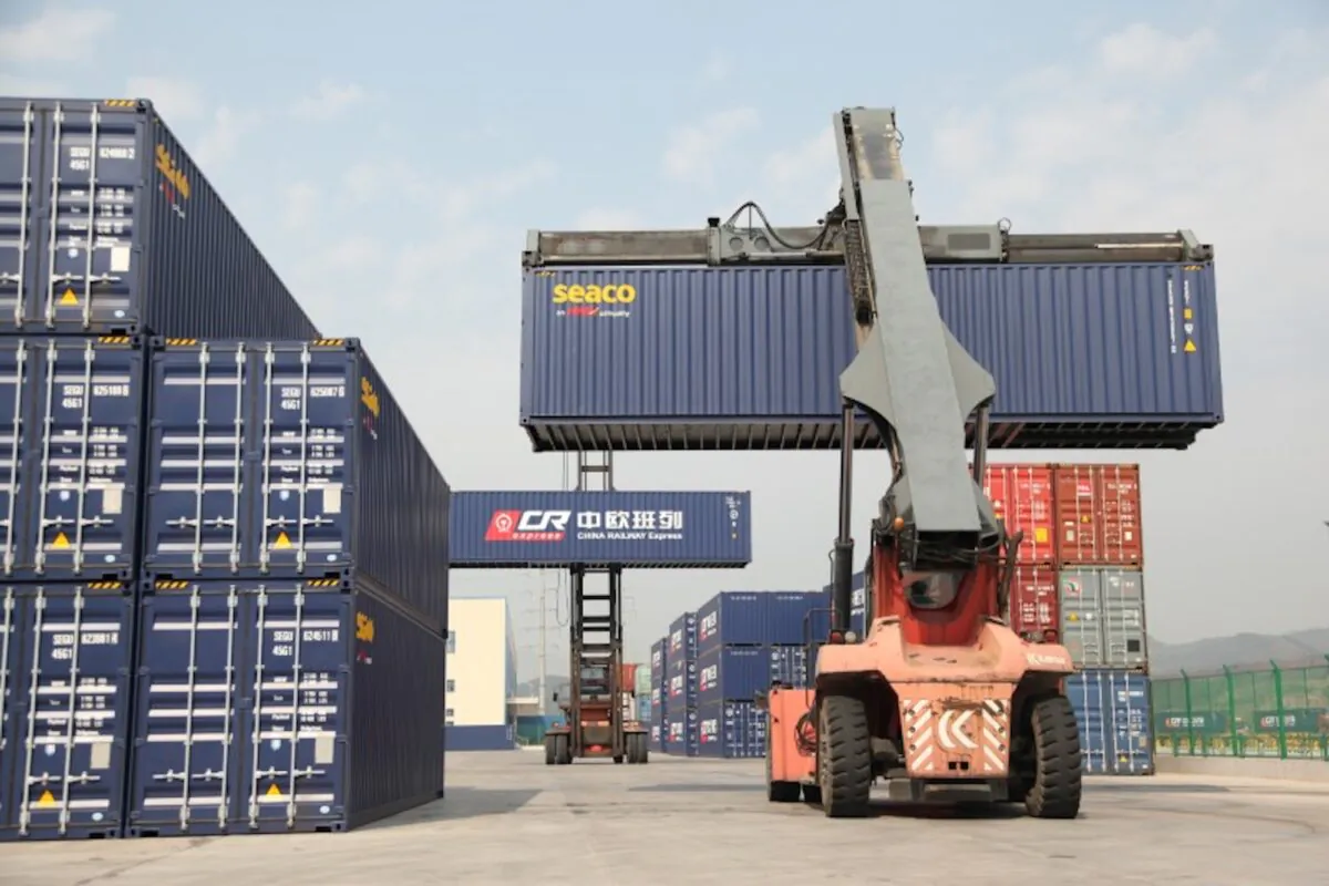 Container handlers transport containers at the railway port in Yiwu, Zhejiang Province, China on April 15, 2017. (Reuters)