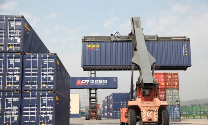 Container handlers transport containers at the railway port in Yiwu, Zhejiang Province, China on April 15, 2017. (Reuters)