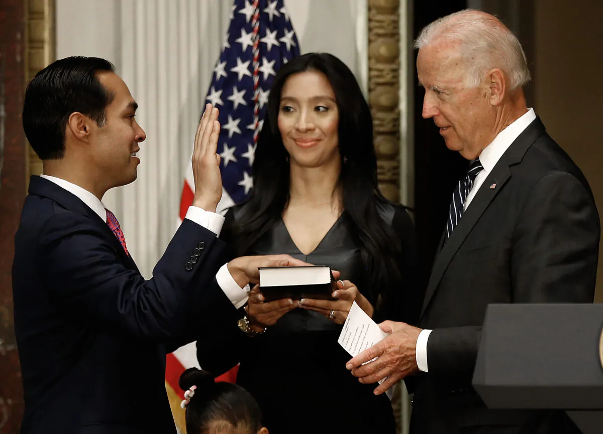 Vice President Joe Biden (R) swears in Secretary of Housing and Urban Development Julian Castro (L) as his wife Erica and daughter Carina look on during a ceremonial swearing in ceremony in the Eisenhower Executive Office Building in Washington on Aug. 18, 2014. (Win McNamee/Getty Images)