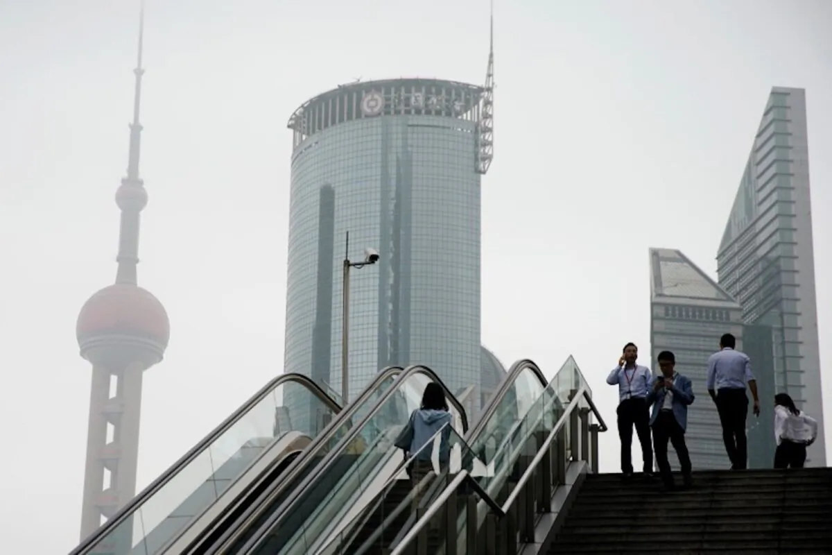 People walk near skyscrapers at Lujiazui financial district in Shanghai, China on May, 16, 2019. (Aly Song/Reuters)