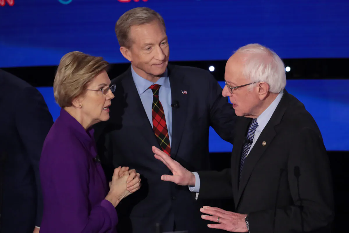Sen. Elizabeth Warren (D-Mass.) and Sen. Bernie Sanders (I-Vt.) speak as Tom Steyer looks on after the Democratic presidential primary debate at Drake University in Des Moines, Iowa on Jan. 14, 2020. Six candidates out of the field qualified for the first Democratic presidential primary debate of 2020. (Scott Olson/Getty Images)