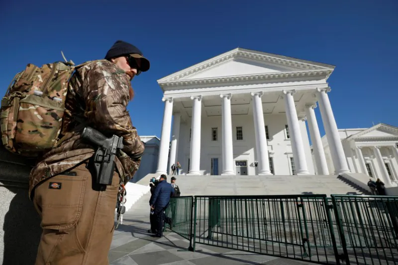 A gun rights activist carries his handgun in a hip holster outside the Virginia State Capitol building as the General Assembly prepares to convene in Richmond, Virginia, on Jan. 8, 2020. (REUTERS/Jonathan Drake)