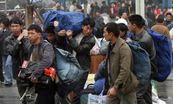 Unable to make a living in China's countryside, many young people go to big cities to perform labor as migrant workers. (MARK RALSTON/AFP via Getty Images)