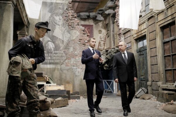 Russian President Vladimir Putin, right, examines an exhibition depicting a Berlin street after surrender in 1945 at 3D panorama 'Memory speaks.
