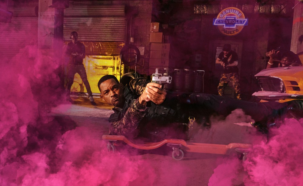 man on ground with gun and pink smoke in "Bad Boys For Life."
