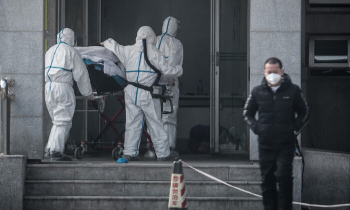 Medical staff members carry a patient into the Jinyintan hospital, where patients infected by a mysterious SARS-like virus are being treated, in Wuhan in China's central Hubei province on Jan. 18, 2020. (STR/AFP via Getty Images)