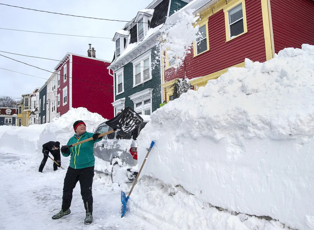 Residents dig out their car in St. John’s on Jan. 19, 2020. The City of St. John's declared a state of emergency in the aftermath of the major winter storm that hit the Newfoundland and Labrador capital, leaving businesses closed and vehicles off the road. (The Canadian Press/Andrew Vaughan)