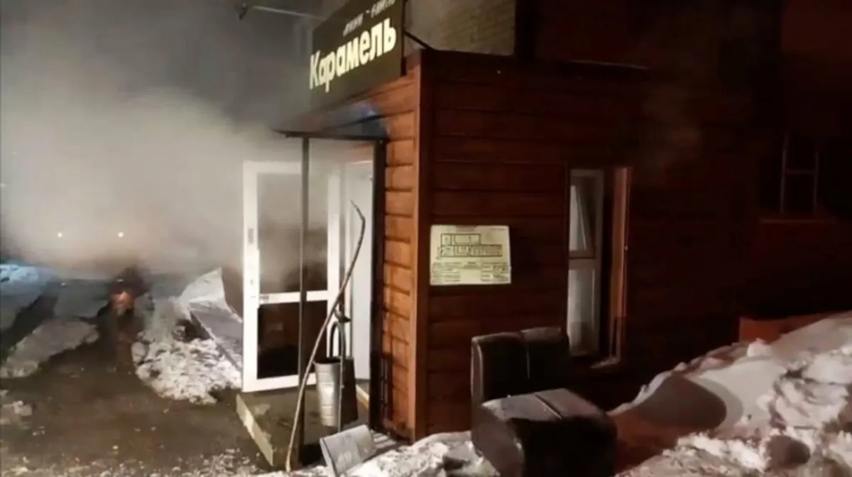 Steam comes out from a door of the Mini Hotel Caramel after a hot water pipe exploded in the night and flooded a basement hotel room with boiling water, in Perm, Russia, on Jan. 20, 2020. (Russian Emergencies Ministry/ Handout via Reuters)