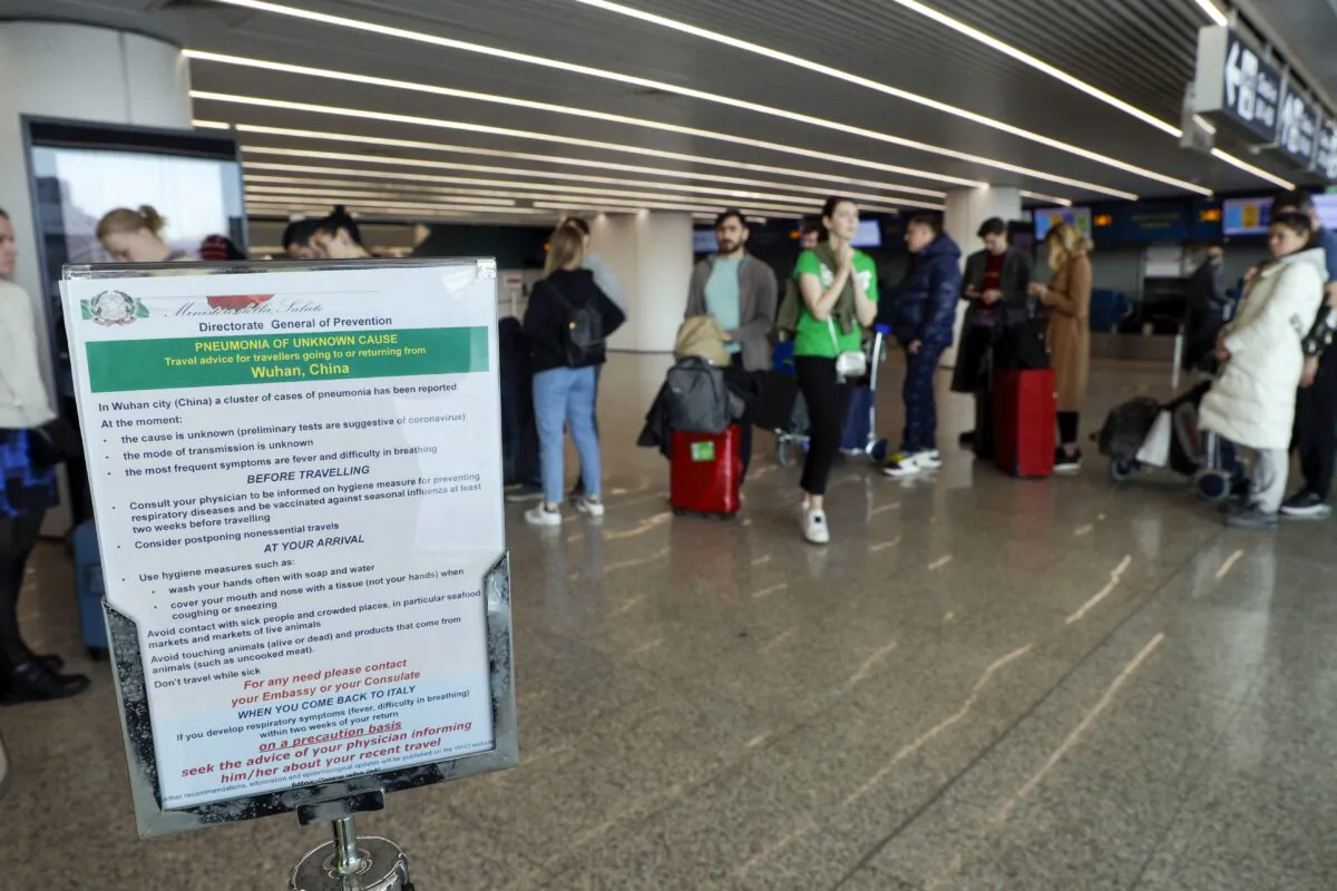 A notice explaining precautions to be taken by people traveling to Wuhan, China, at a terminal of the Rome Fiumicino International Airport in Italy on Jan. 21, 2020. (AP Photo/Gregorio Borgia)