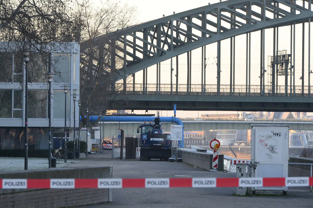 The excavator that uncovered the bomb stands in front of the Hohenzollern Bridge in Cologne, Germany, on Jan. 21, 2020. (Roberto Pfeil/dpa via AP)