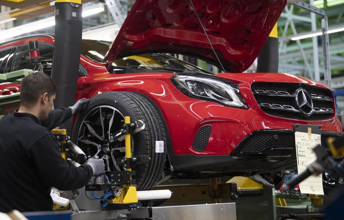An employee mounts a wheel on a Mercedes Benz A Class on the assembly line at the Daimler AG factory in Rastatt, Germany, on Feb. 4, 2019. (Thomas Kienzle/AFP via Getty Images)