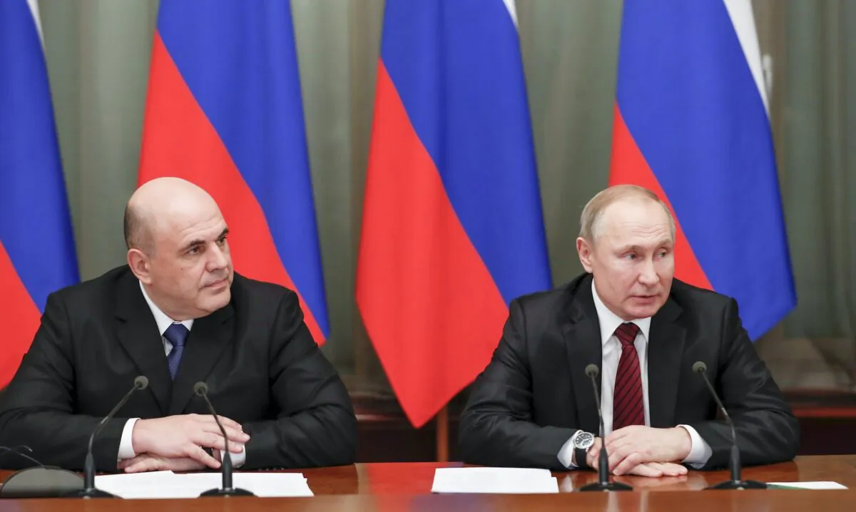 Russian President Vladimir Putin (R) and new Russian Prime Minister Mikhail Mishustin attend a new cabinet meeting in Moscow, Russia, on Jan. 21, 2020. (Dmitry Astakhov, Sputnik, Government Pool Photo via AP)