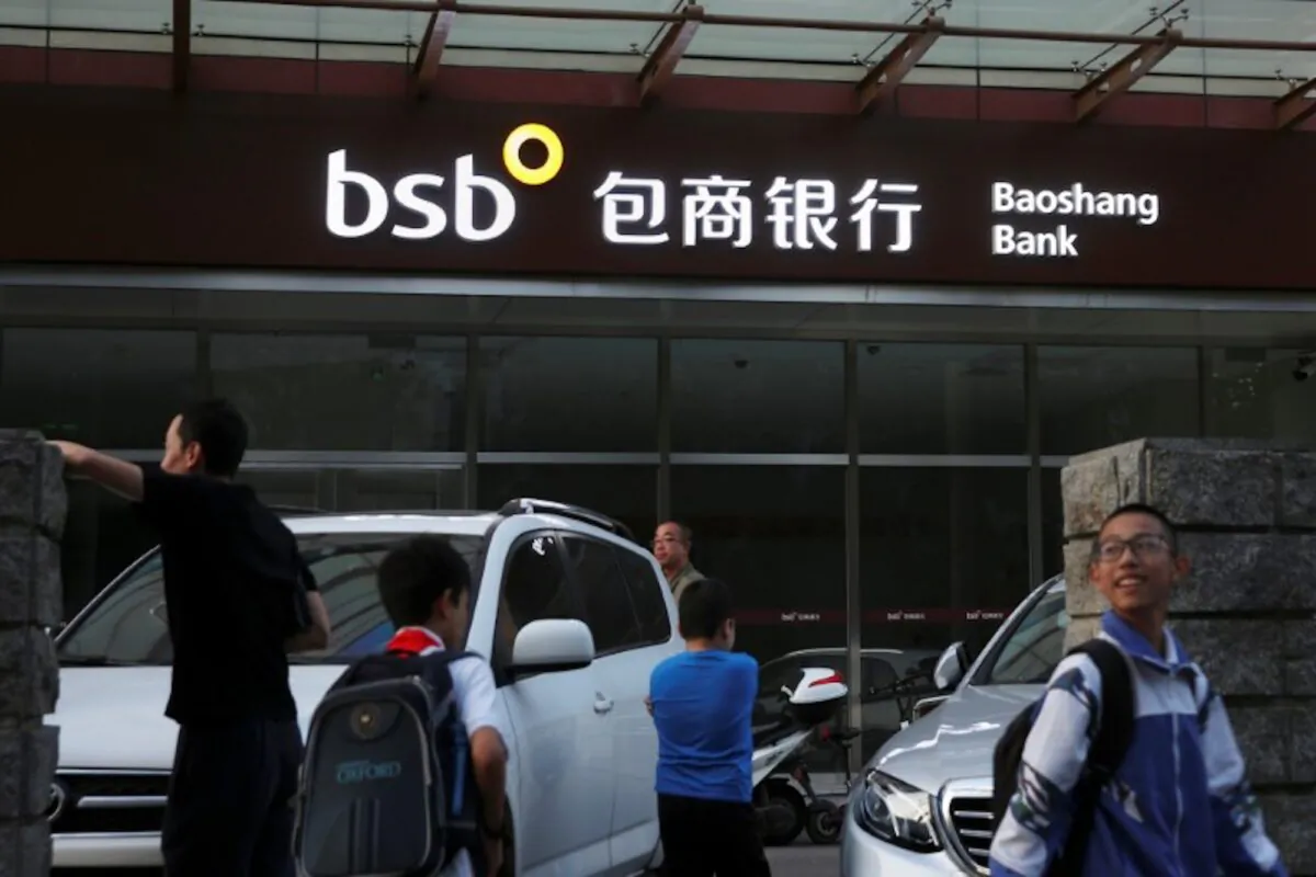 People walk past a branch of Baoshang Bank in Beijing, China on Sept. 24, 2019. (Reuters)