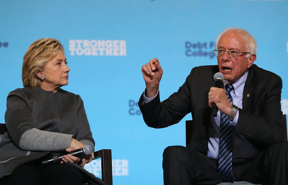 Democratic presidential nominee former Secretary of State Hillary Clinton (L) looks on as Sen. Bernie Sanders (I-Vt.) speaks during a campaign rally at University of New Hampshire in Durham, New Hampshire, on Sept. 28, 2016. (Justin Sullivan/Getty Images)