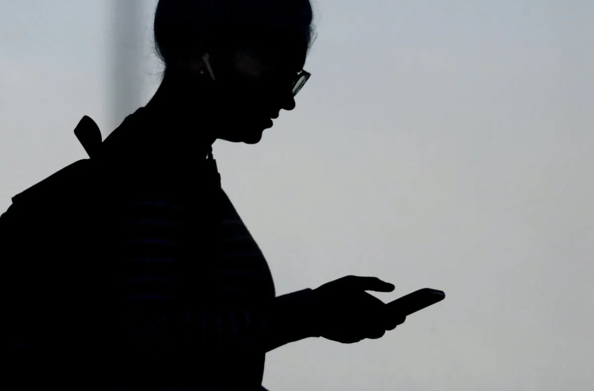 A woman checks her phone in Orem, Utah, on Nov. 14, 2019. (Rick Bowmer/AP Photo)