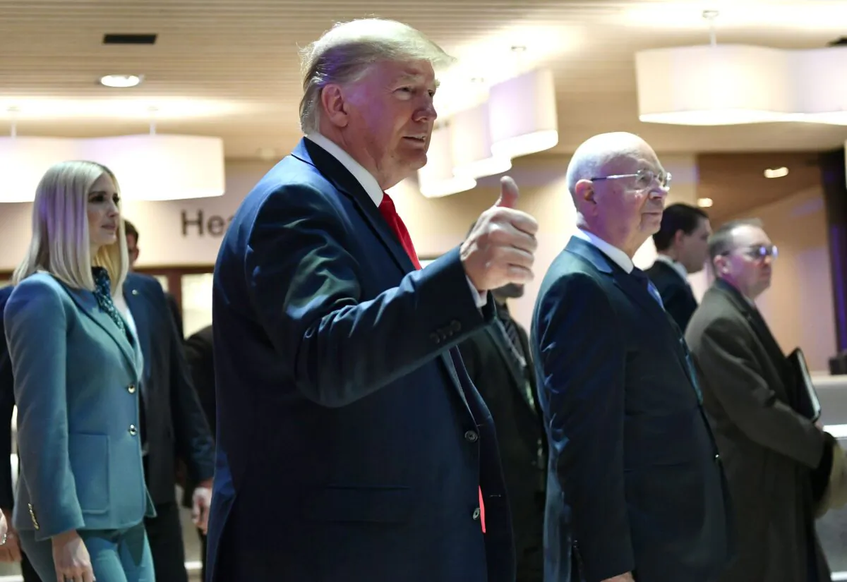 President Donald Trump (C) gestures flanked by her daughter White House Senior Advisor Ivanka Trump and World Economic Forum (WEF) founder and executive chairman Klaus Schwab, as they arrive at the Congress center during the WEF annual meeting in Davos on Jan. 22, 2020. Fabrice Coffrini/AFP via Getty Images