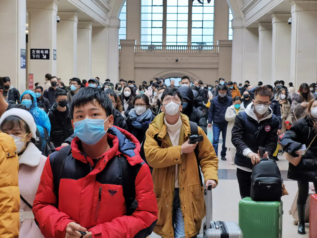 People wear face masks as they wait at Hankou Railway Station in Wuhan City, China on Jan. 22, 2020. A new infectious coronavirus known as "2019-nCoV" was discovered in Wuhan last week. (Xiaolu Chu/Getty Images)