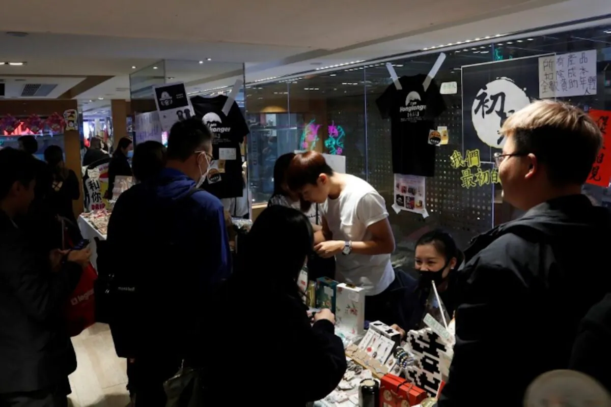 Customers walk past at a booth of independent fairs, selling protest-themed artwork, toys and accessories, ahead of Lunar New Year in Hong Kong, China on Jan. 20, 2020. (Tyrone Siu/Reuters)