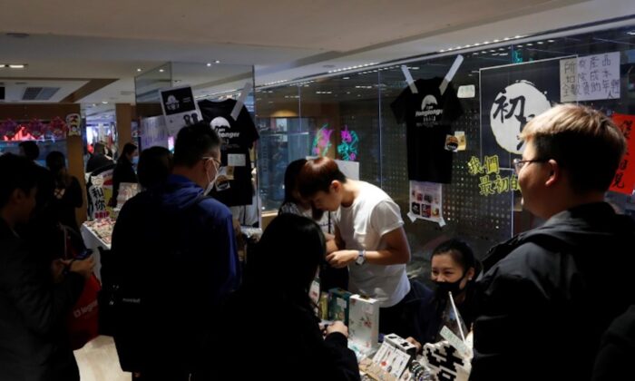 Customers walk past at a booth of independent fairs, selling protest-themed artwork, toys and accessories, ahead of Lunar New Year in Hong Kong, China on Jan. 20, 2020. (Tyrone Siu/Reuters)