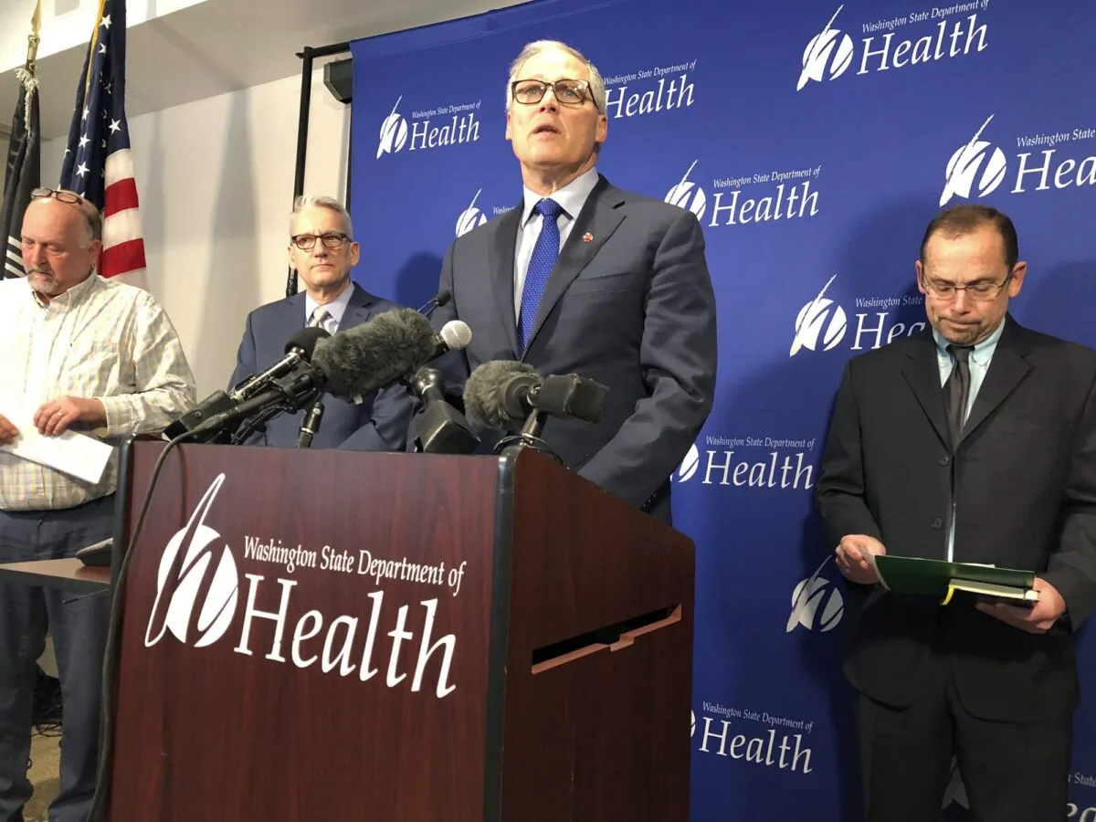 Washington Gov. Jay Inslee (C) speaks at a news conference following the announcement that a man in Washington state is the first known person in the United States to catch a new type of coronavirus that officials believe originated in China, in Shoreline, Wash., on Jan. 21, 2020. (Carla K. Johnson/AP Photo)