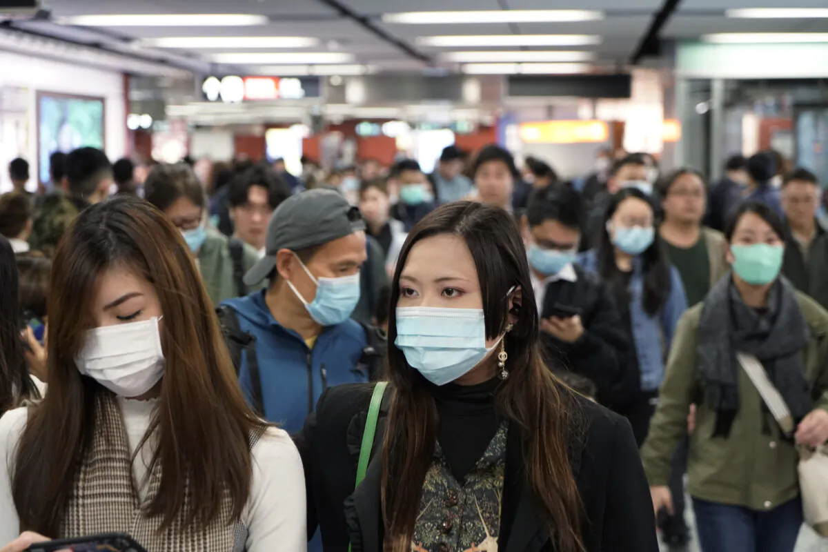 Passengers wear masks to prevent an outbreak of a new coronavirus in a subway station, in Hong Kong on Jan. 22, 2020. (Kin Cheung/AP Photo)