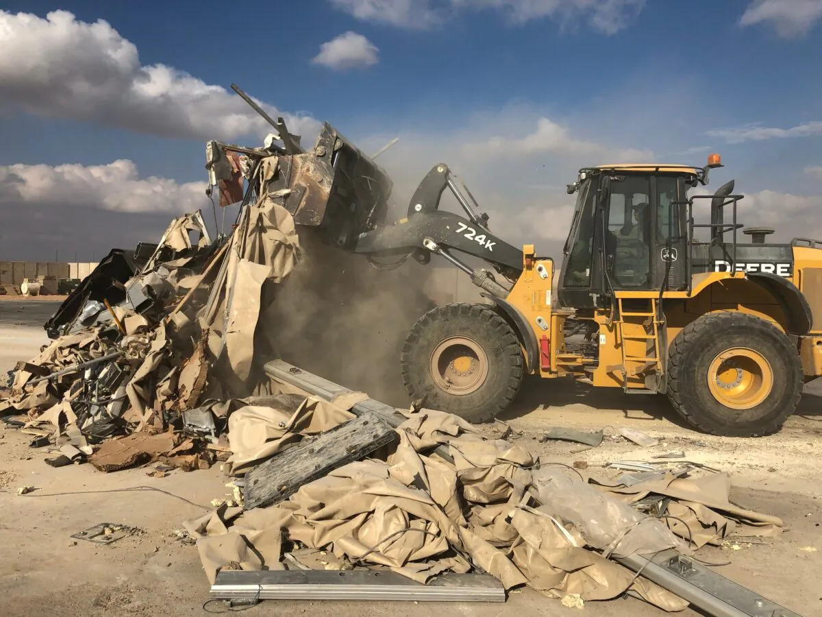 A bulldozer clears rubble and debris at Ain al-Asad air base in Anbar, Iraq, Monday, Jan. 13, 2020. Ain al-Asad air base was struck by a barrage of Iranian missiles in retaliation for the U.S. drone strike that killed atop Iranian commander, Gen. Qassem Soleimani, whose killing raised fears of a wider war in the Middle East. (AP Photo/Qassim Abdul-Zahra)