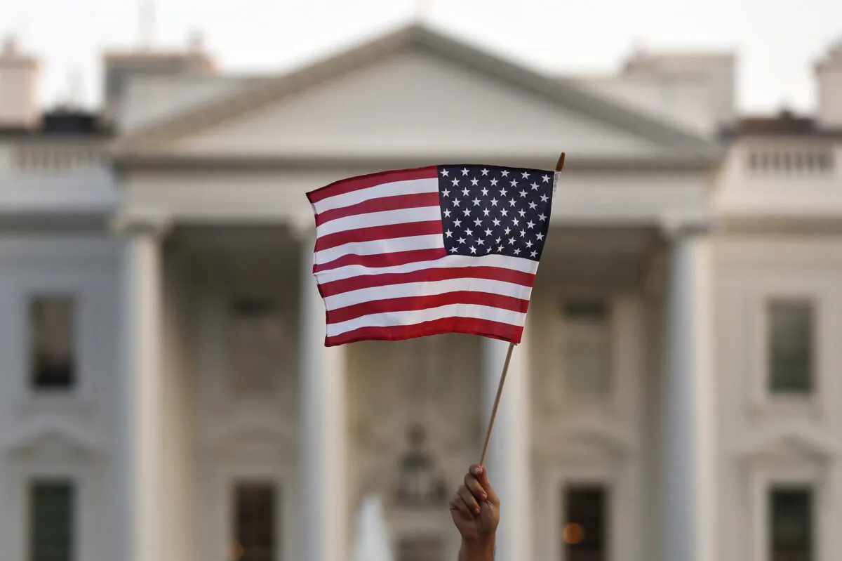 A flag is waved outside the White House in this Sept. 2017 file photo. (Carolyn Kaster/AP Photo)