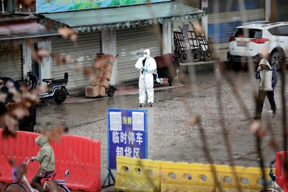 A worker in a protective suit is seen at the closed seafood market in Wuhan, Hubei Province, China on Jan. 10, 2020. (Reuters)