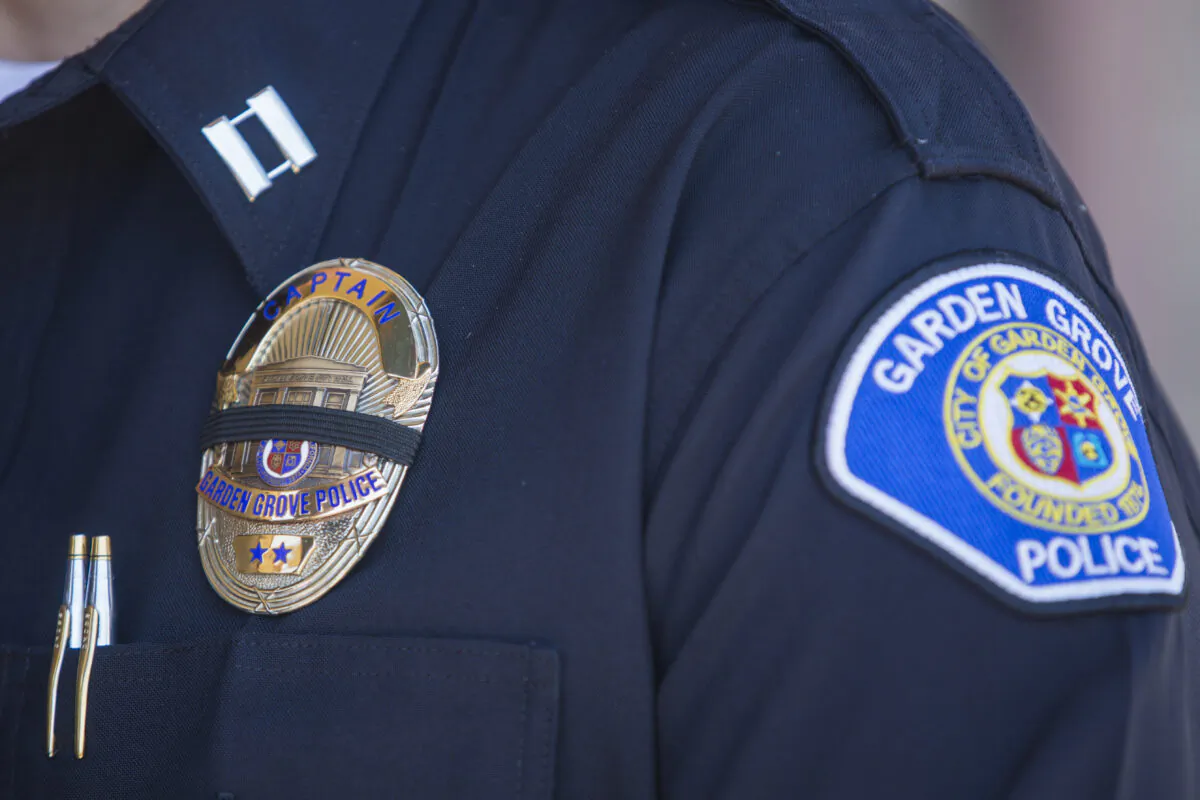A police officer wears a badge with a mourning band during a press conference in front of the Garden Grove Police Department in Garden Grove, Calif. on Aug. 8, 2019. (Apu Gomes/AFP via Getty Images)
