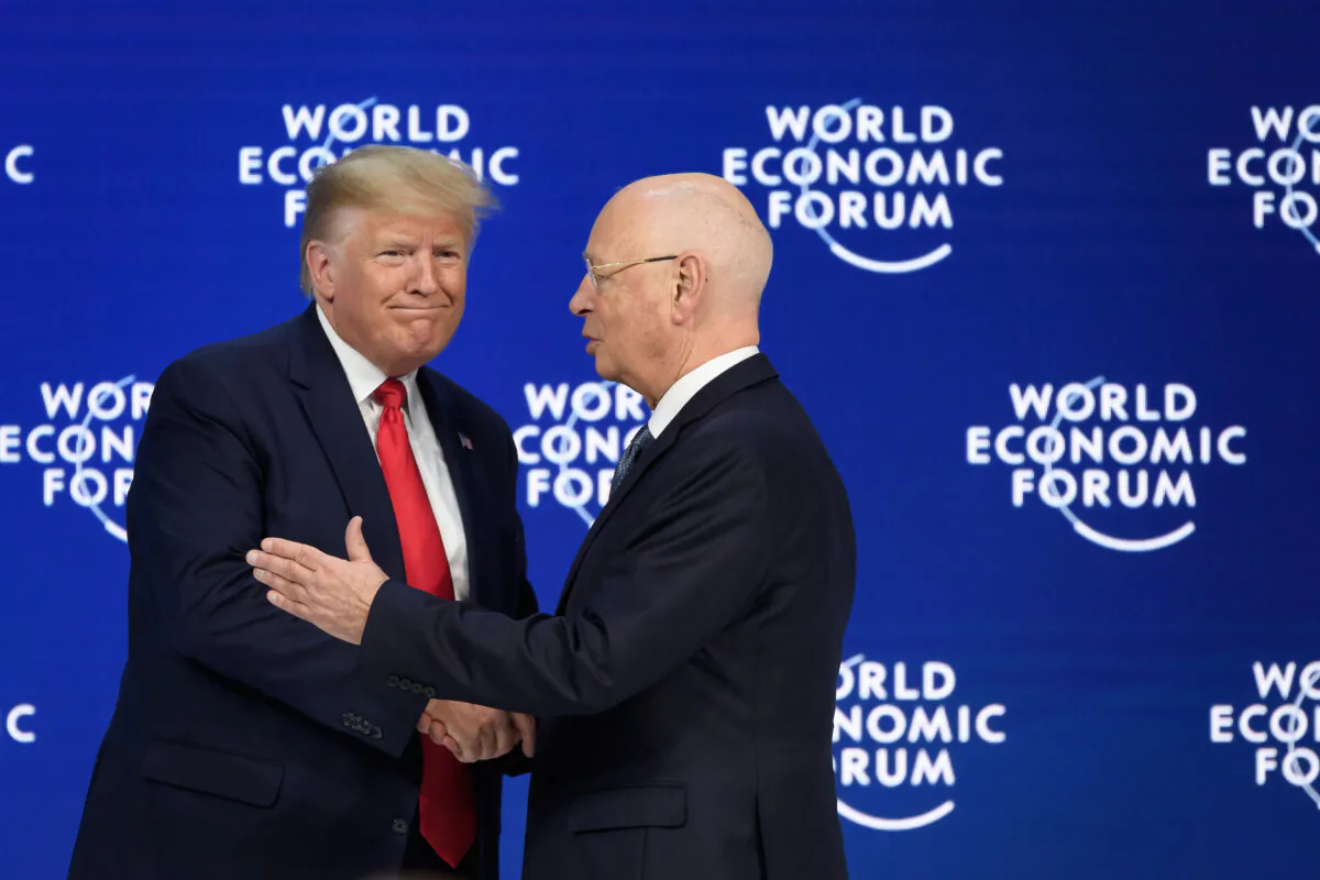 President Donald Trump (L) shakes hands to World Economic Forum (WEF) founder and executive chairman Klaus Schwab after he deliverend a speech at the Congress centre during the World Economic Forum (WEF) annual meeting in Davos, on Jan. 21, 2020. (Fabrice Coffrini/AFP via Getty Images)