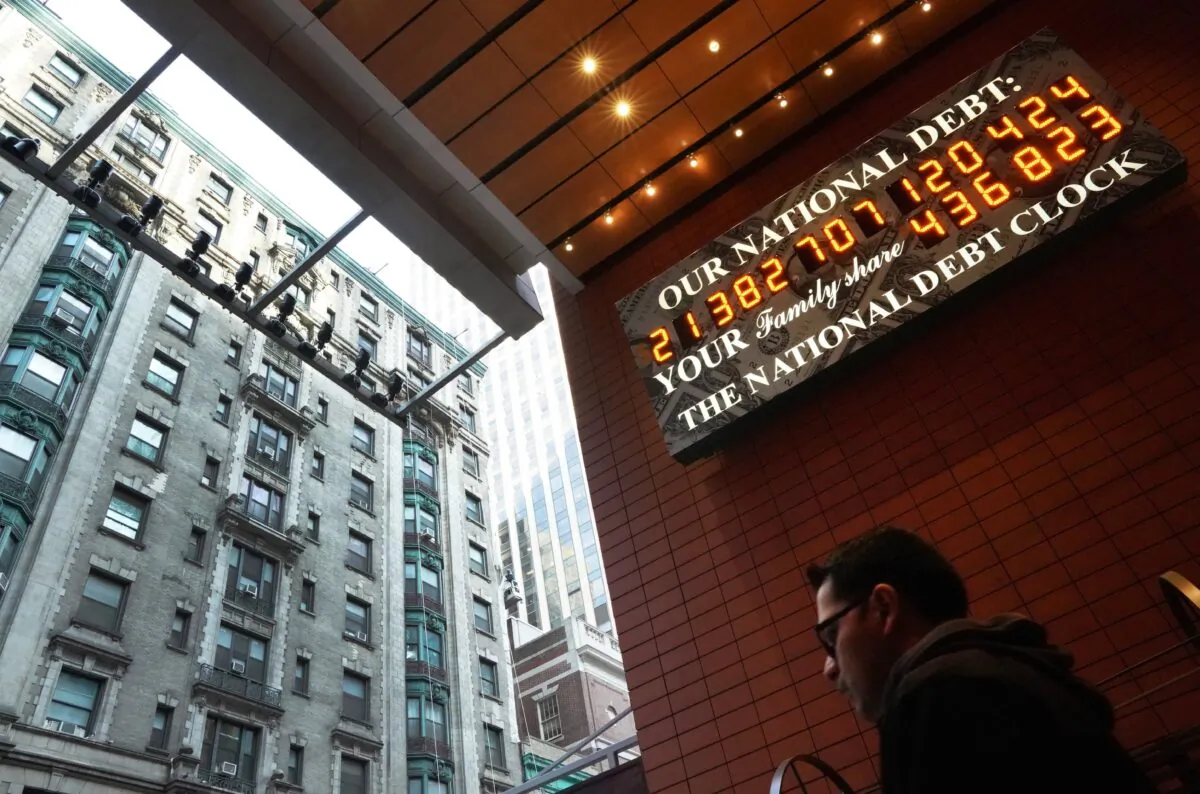 A man walks past the he National Debt Clock on 43rd Street in midtown New York City on Feb. 15, 2019. (Timothy A. Clary/AFP via Getty Images)