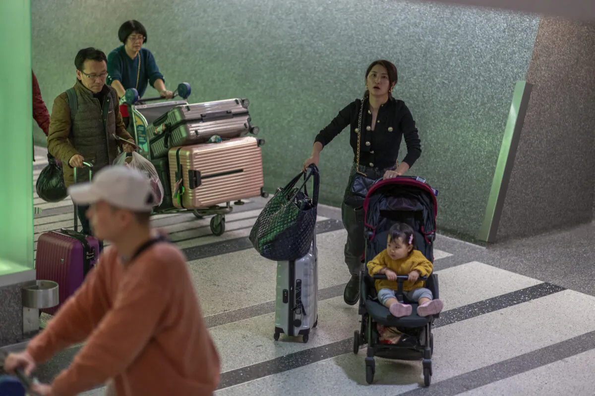 People arrive to Los Angeles International Airport after touchdown of an Air China flight from Beijing, which serves as a connector from Wuhan, China to Los Angeles, on the first day of health screenings for coronavirus of travelers from Wuhan, on Jan. 18, 2020. (David McNew/Getty Images)