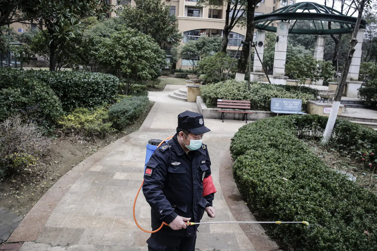 A security guard sprays alcohol to disinfect areas in Wuhan City, Hubei Province, China on Jan. 23, 2020. (Getty Images)