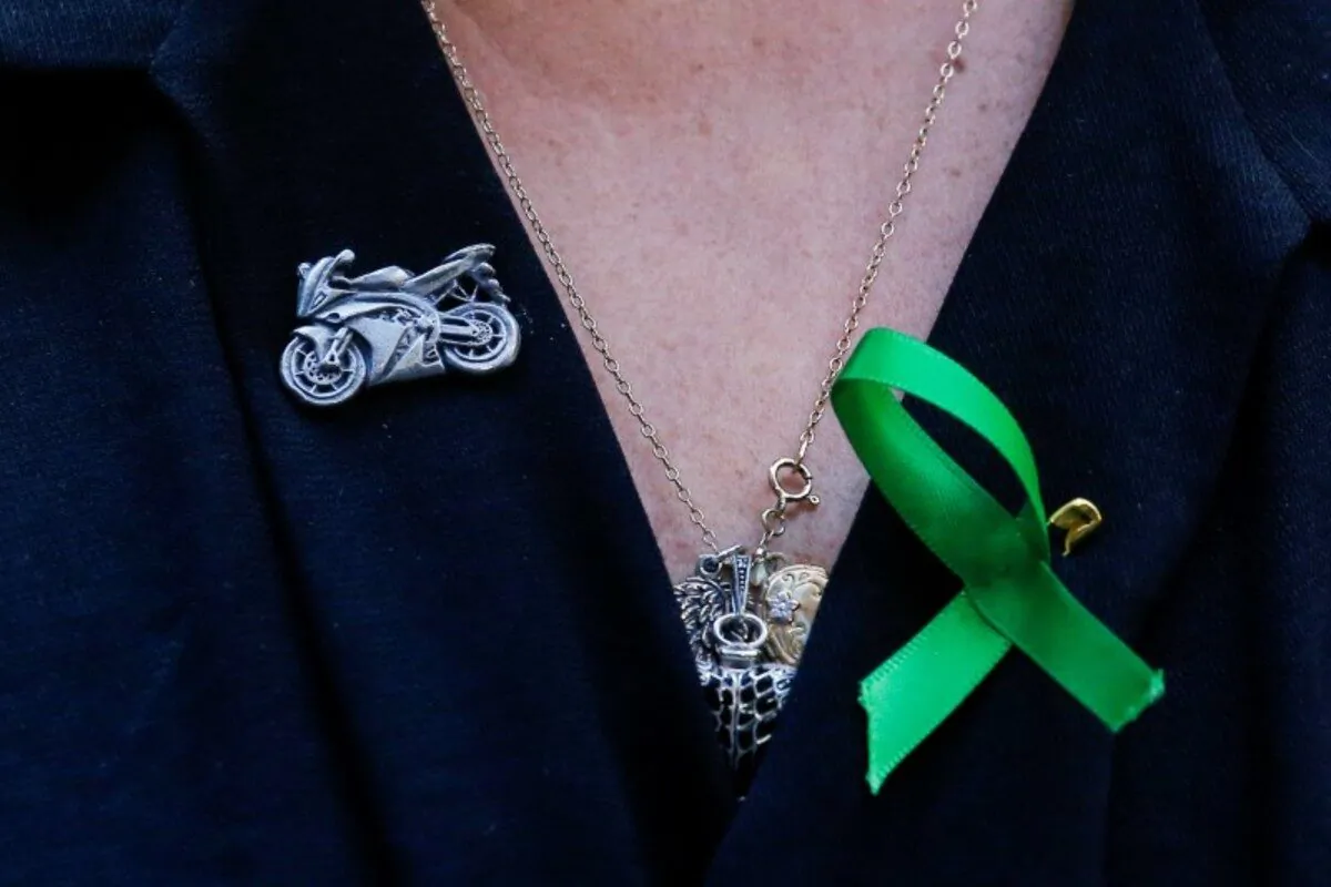 A motorcycle pin is seen on the shirt of Charlotte Charles, the mother of British teen Harry Dunn who was killed in a car crash on his motorcycle, during an interview in the Manhattan borough of New York City, N.Y., on Oct.15, 2019. (Eduardo Munoz/Reuters)