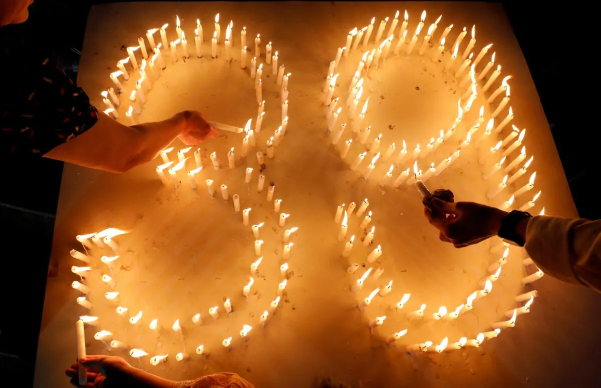 Catholic believers light candles during a mass payer for 39 Vietnamese people found dead in a truck near London last month, at a church in Nghe An province, Vietnam, on Nov.30,2019. (Kham/ Reuters)