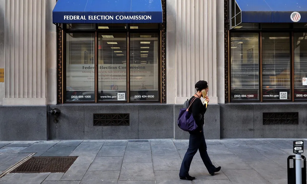 A pedestrian walks past the Federal Election Commission's headquarters in Washington on Oct. 24, 2016. Chip Somodevilla/Getty Images
