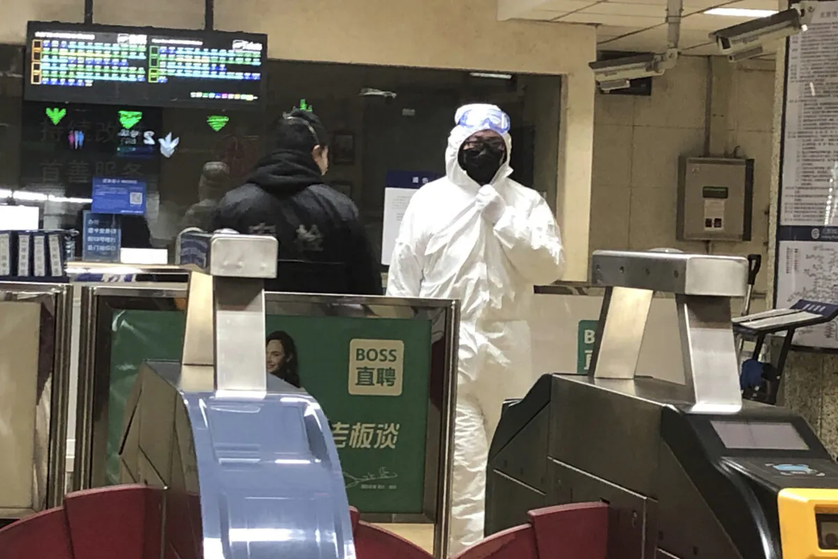 A security officer wears a hazardous materials suit at a subway station in Beijing, China amid the Wuhan coronavirus outbreak on Jan. 24, 2020. (Yunan Wang/AP Photo)