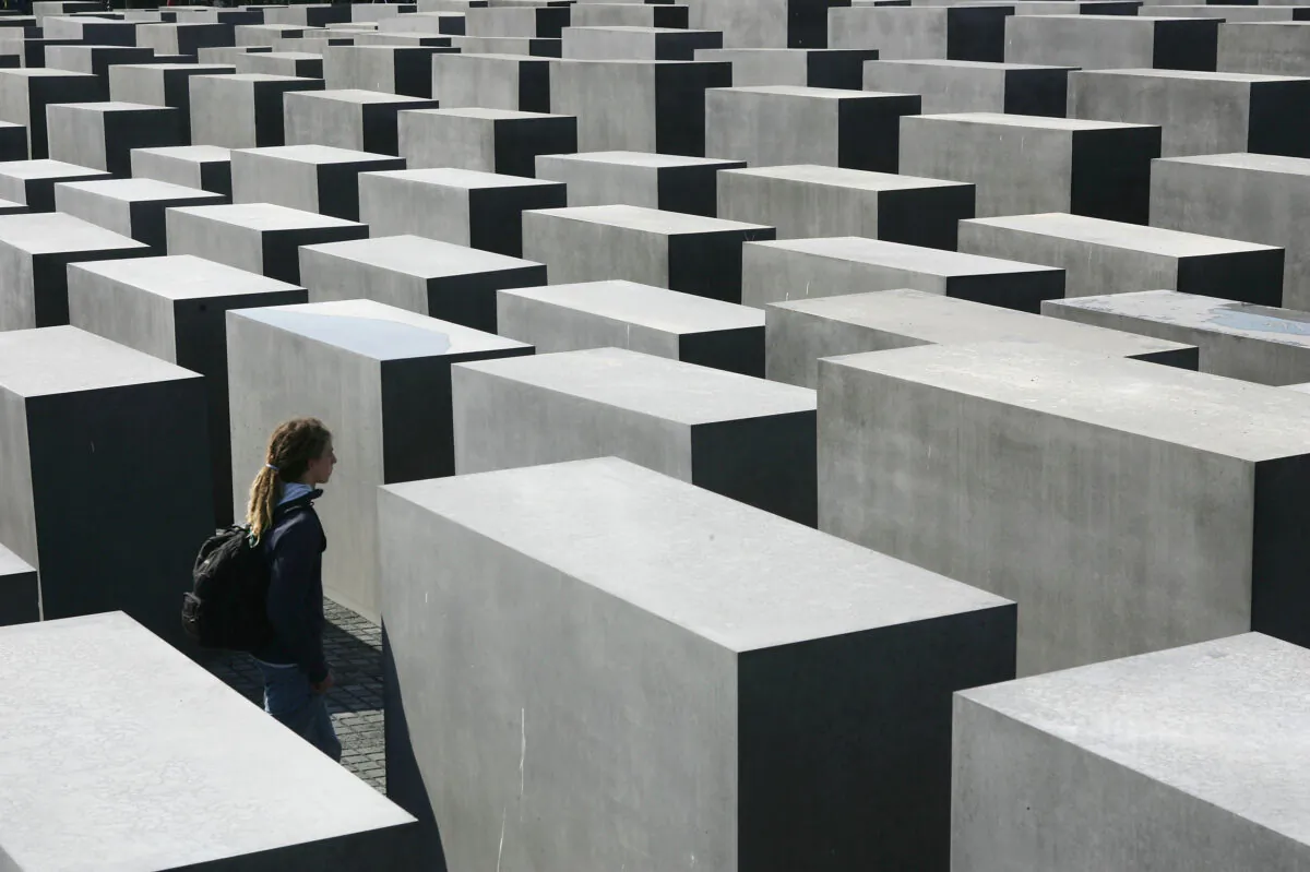A visitor walks among the 2,711 stellae at the Memorial to the Murdered Jews of Europe on the first day of its opening to the public in Berlin, Germany, on May 12, 2005. The monument, a Holocaust memorial, was designed by American architect Peter Eisenman and commemorates the 6 million Jews murdered by the Nazis. The memorial has been a controversial project in the heart of Berlin 17 years in the making. Sean Gallup/Getty Images