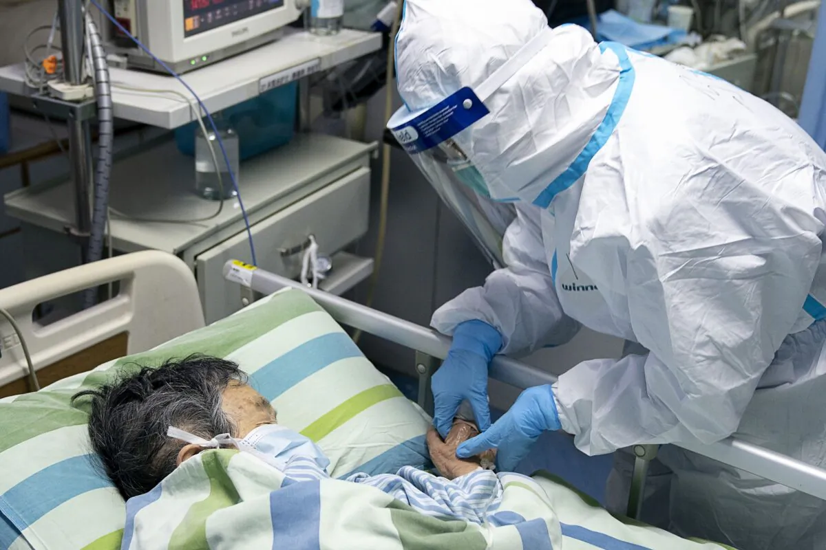 A medical worker attends to a patient in the intensive care unit at Zhongnan Hospital of Wuhan University in Wuhan in central China's Hubei Province on Jan. 24, 2020. (Zong Qi/Xinhua via AP)