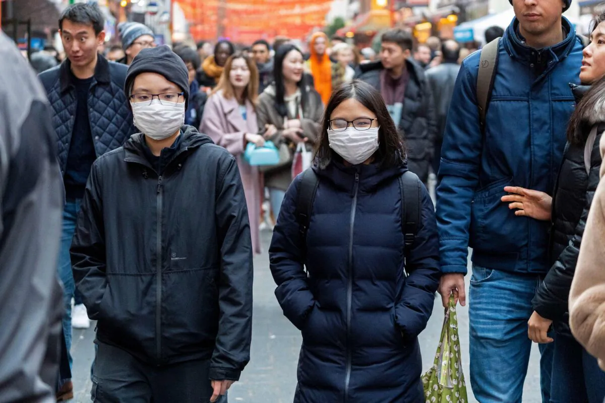 Pedestrians are seen wearing surgical masks in London's Chinatown on Jan. 25, 2020. (Niklas Halle'n/AFP via Getty Images)