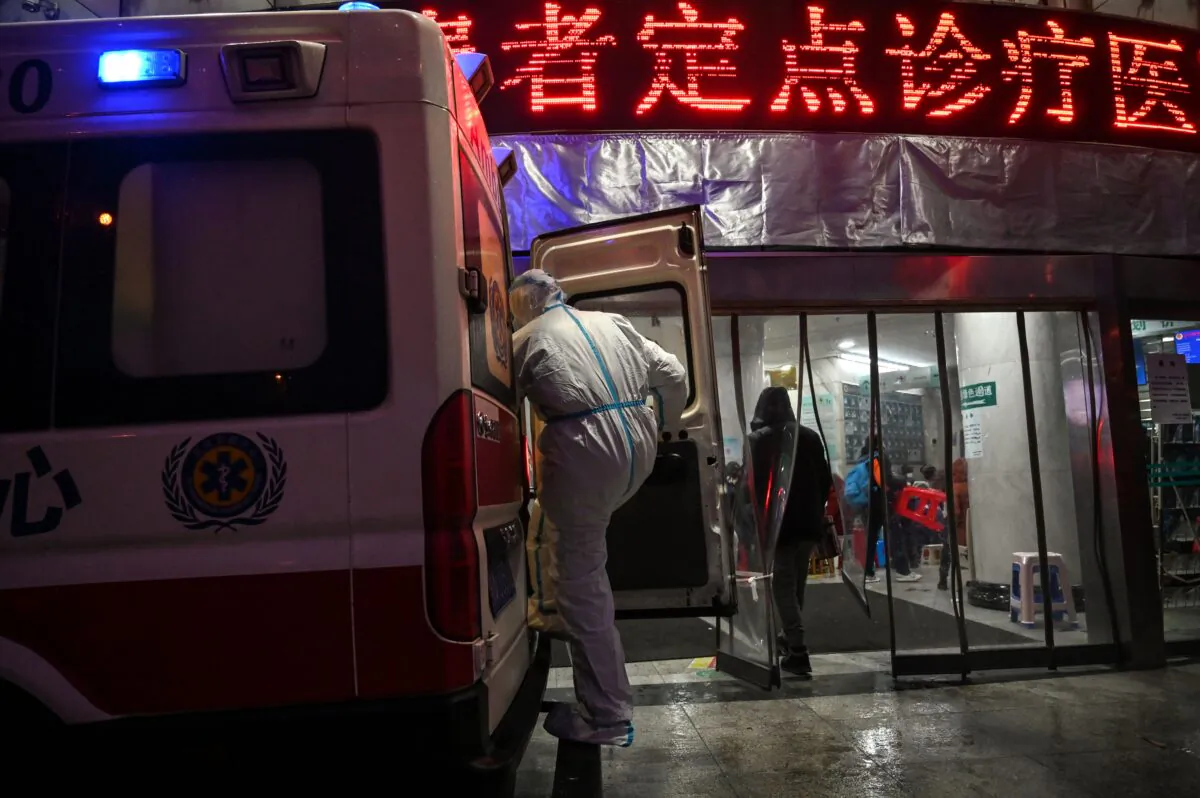 A medical staff member, wearing protective clothing to help stop the spread of a deadly virus that began in the city, boards an ambulance at the Wuhan Red Cross Hospital in Wuhan on Jan. 25, 2020. (Hector Retamal/AFP via Getty Images)