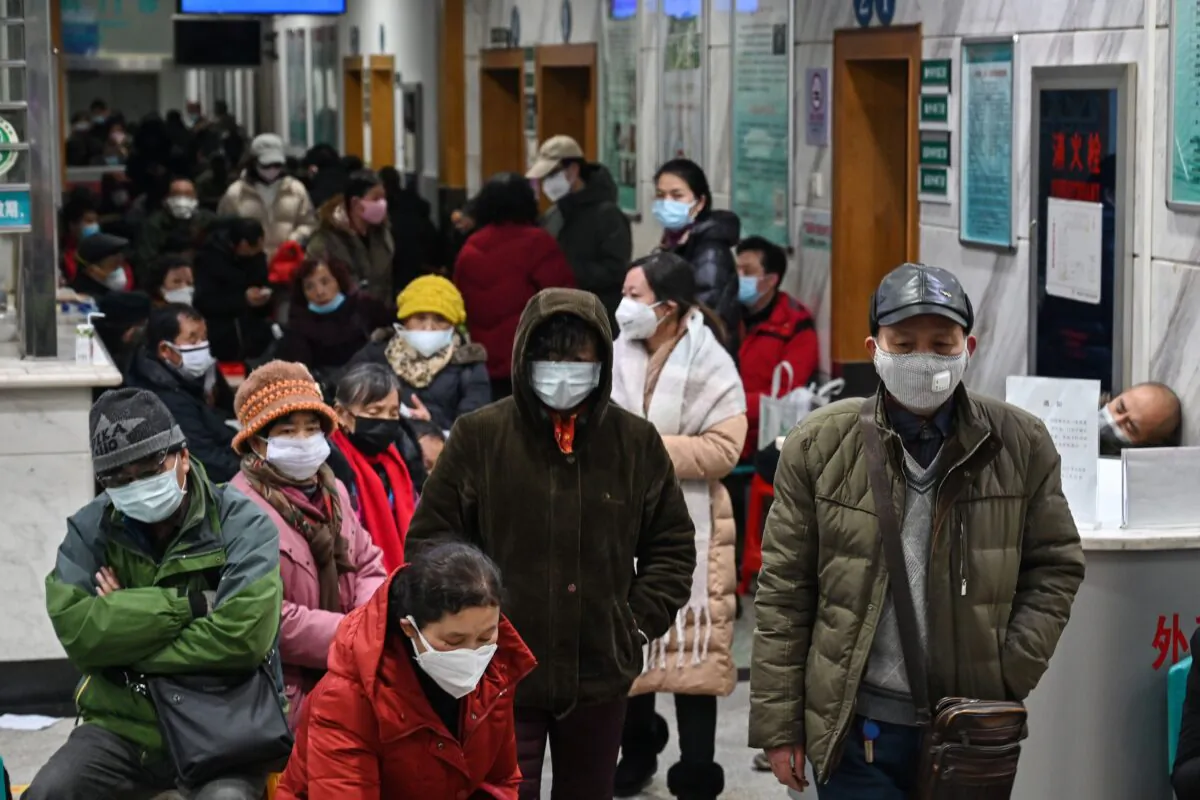 People wearing facemasks to help stop the spread of a deadly virus which began in the city, wait for medical attention at Wuhan Red Cross Hospital in Wuhan, China, on Jan. 25, 2020. (Hector Retamal/AFP via Getty Images)