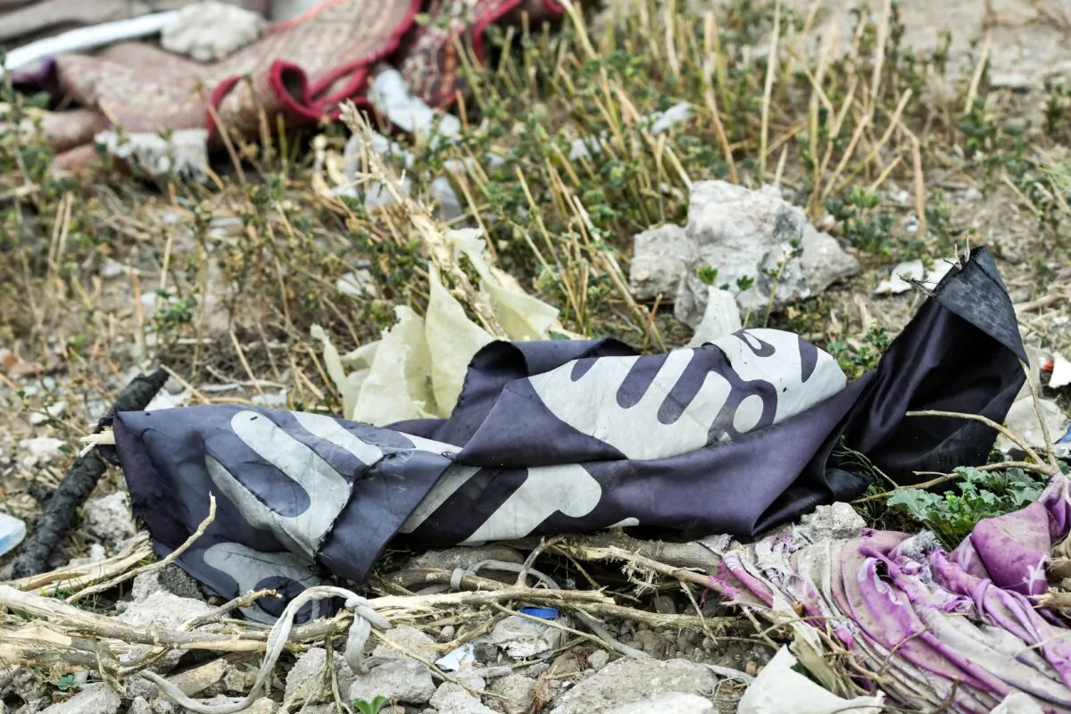 A discarded ISIS terrorist group flag lies on the ground in the village of Baghouz in Syria's eastern Deir Ezzor province near the Iraqi border, on March 24, 2019. (Giuseppe Cacace/AFP via Getty Images)