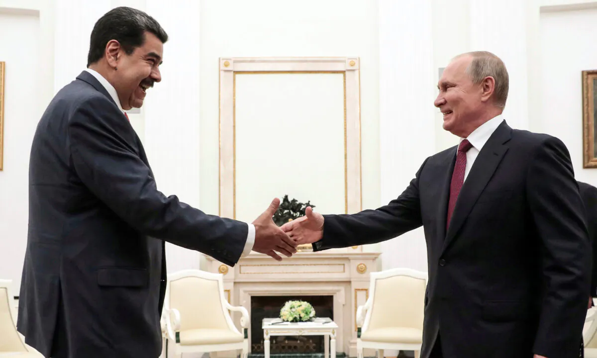 Russian President Vladimir Putin (R) shakes hands with Venezuelan President Nicolás Maduro during their meeting at the Kremlin in Moscow on Sept. 25, 2019. (Sergei Chirikov/AFP via Getty Images)