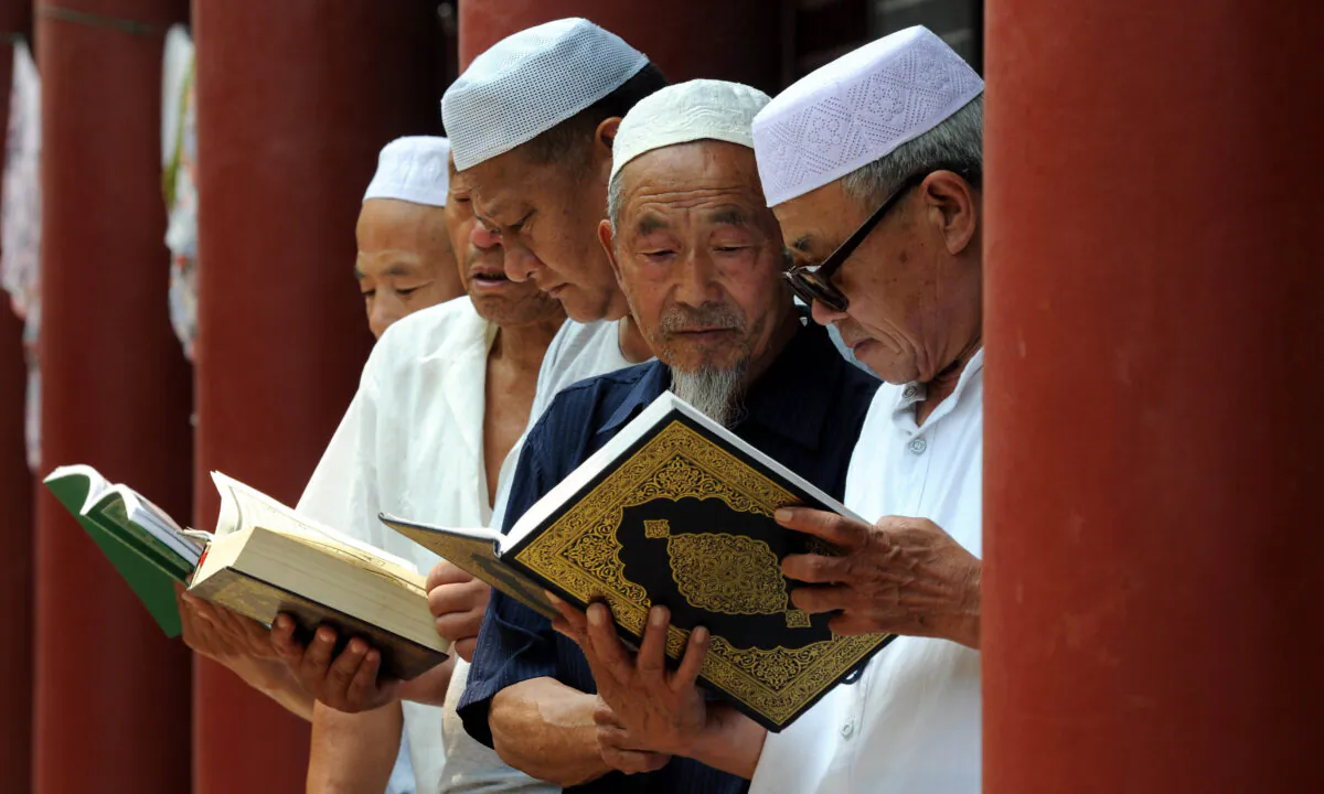 Chinese Muslims read the Koran at a mosque in Tancheng, in eastern China's Shandong Province, at the beginning of the holy month of Ramadan, on June 30, 2014.  -/AFP via Getty Images)